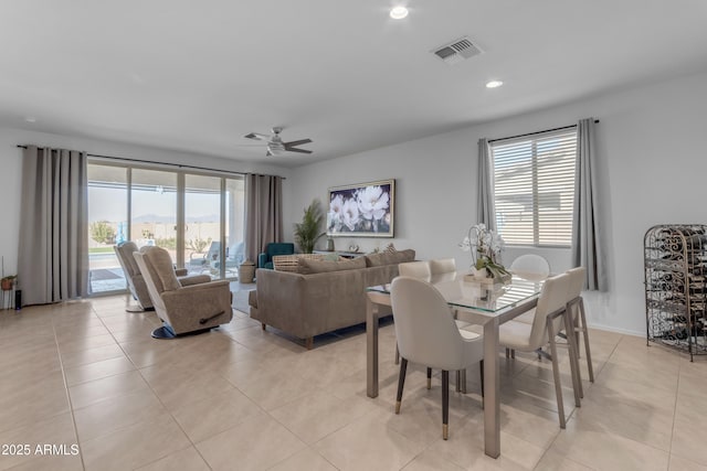 tiled dining room featuring ceiling fan and a healthy amount of sunlight