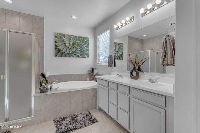 bathroom with vanity, tile patterned flooring, and plus walk in shower