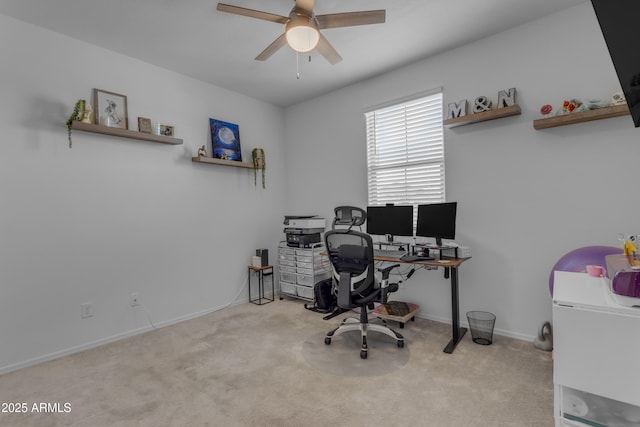 carpeted office featuring ceiling fan