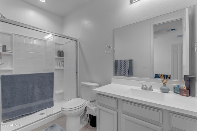 bathroom with tile patterned flooring, vanity, toilet, and a shower with door