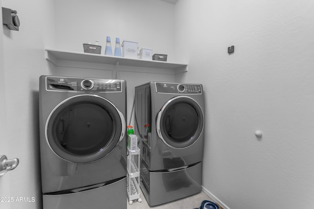 washroom featuring separate washer and dryer and light tile patterned floors