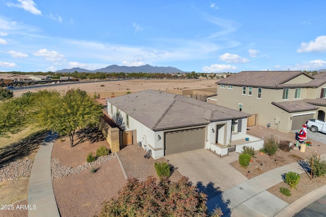 view of front of property with a mountain view and a garage