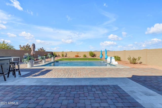 view of swimming pool featuring pool water feature and a patio