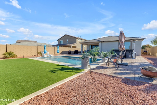 view of swimming pool featuring a yard and a patio area