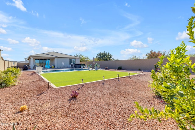 view of yard featuring a fenced in pool and a patio