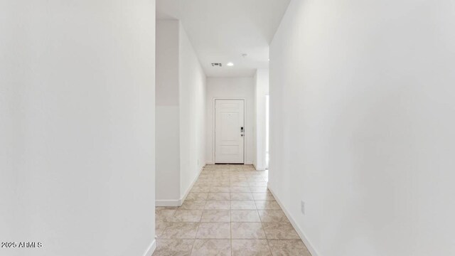 hall with visible vents and baseboards