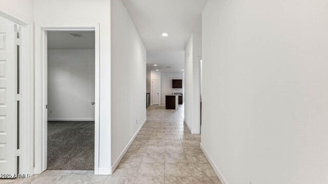 corridor with visible vents, recessed lighting, light colored carpet, and baseboards