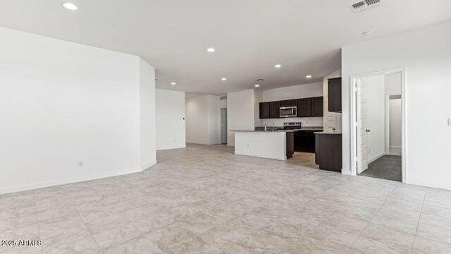 unfurnished living room with recessed lighting and visible vents