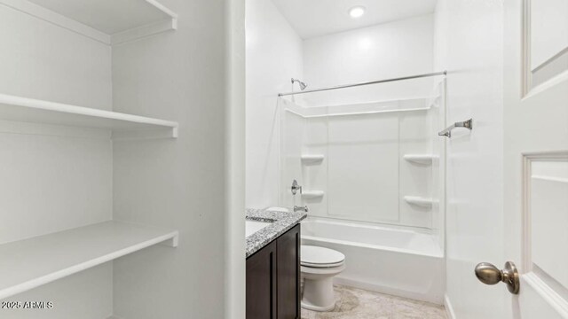 bathroom with toilet, bathing tub / shower combination, and vanity