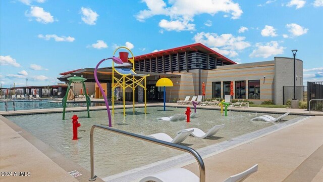 exterior space featuring a pool and playground community