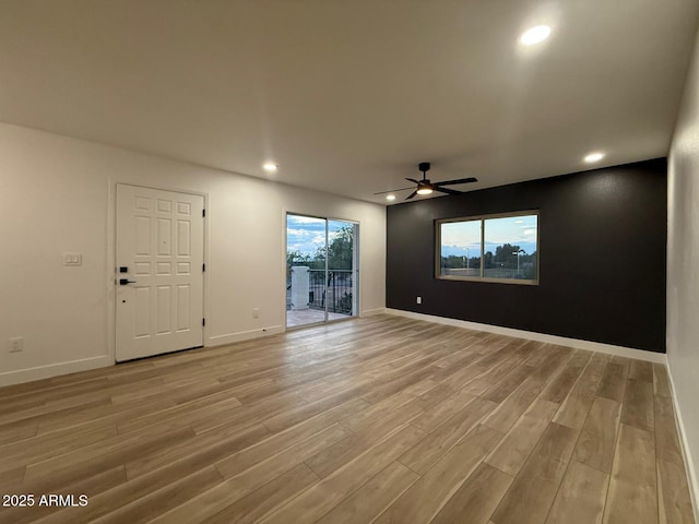 unfurnished room with light wood finished floors, ceiling fan, recessed lighting, and baseboards