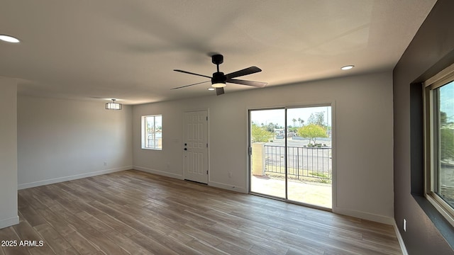 spare room featuring baseboards, wood finished floors, recessed lighting, and ceiling fan