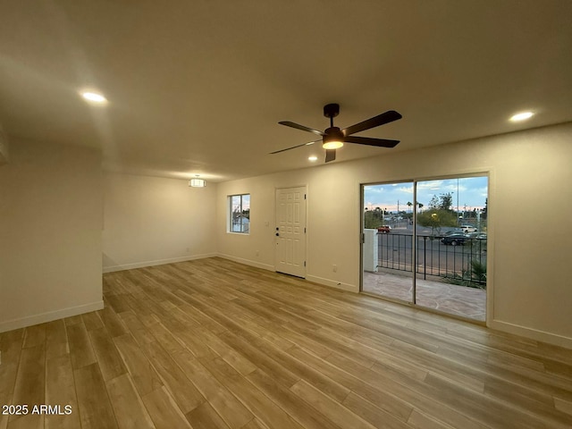 empty room featuring wood finished floors, a ceiling fan, recessed lighting, and baseboards