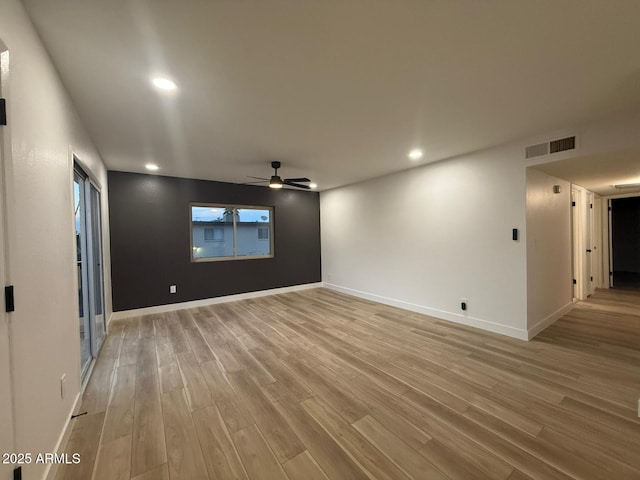 empty room featuring a ceiling fan, light wood-style flooring, recessed lighting, and baseboards