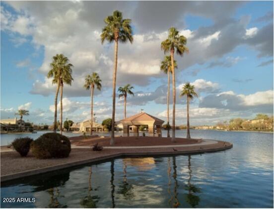 view of swimming pool with a gazebo and a water view