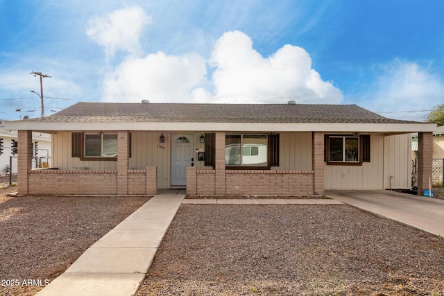 single story home with brick siding, a porch, and fence