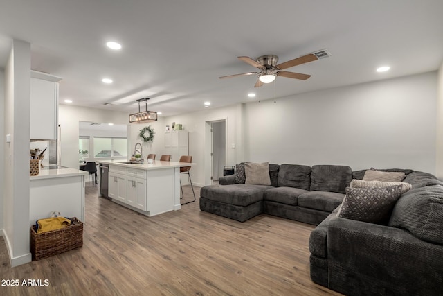 living room featuring recessed lighting, visible vents, ceiling fan, and light wood finished floors