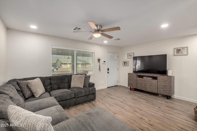 living room featuring recessed lighting, wood finished floors, and visible vents