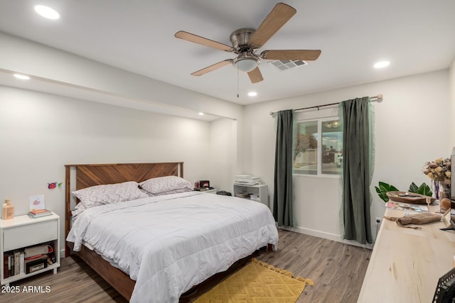 bedroom with a ceiling fan, recessed lighting, wood finished floors, and visible vents