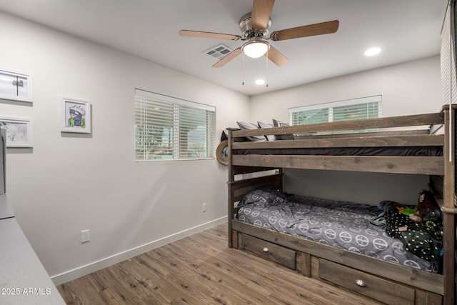 bedroom featuring recessed lighting, wood finished floors, visible vents, and baseboards