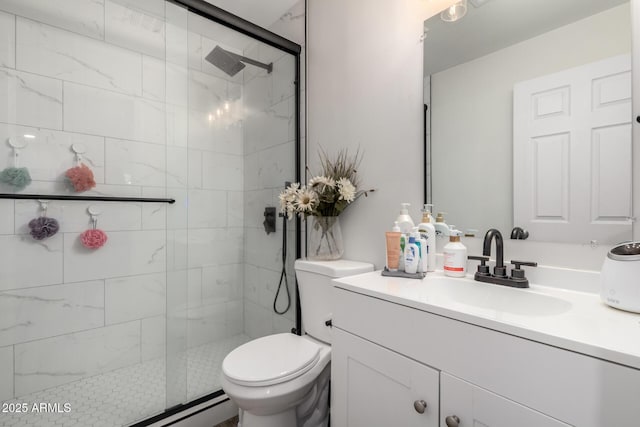 full bathroom featuring vanity, a shower stall, and toilet