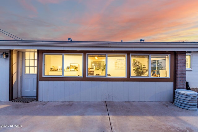 exterior entry at dusk with a patio