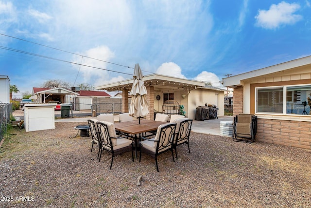 view of patio featuring outdoor dining space and fence