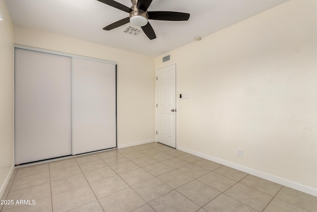 2130 W Colter St, Phoenix, AZ 85015 - unfurnished bedroom with a closet, baseboards, ceiling fan, and light tile patterned flooring