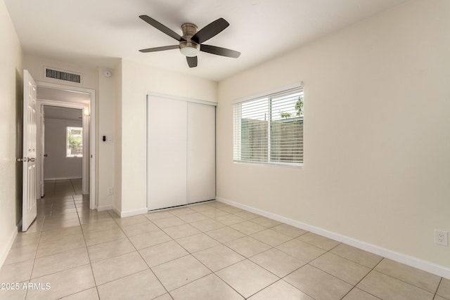 2130 W Colter St, Phoenix, AZ 85015 - unfurnished bedroom with a closet, multiple windows, and light tile patterned floors