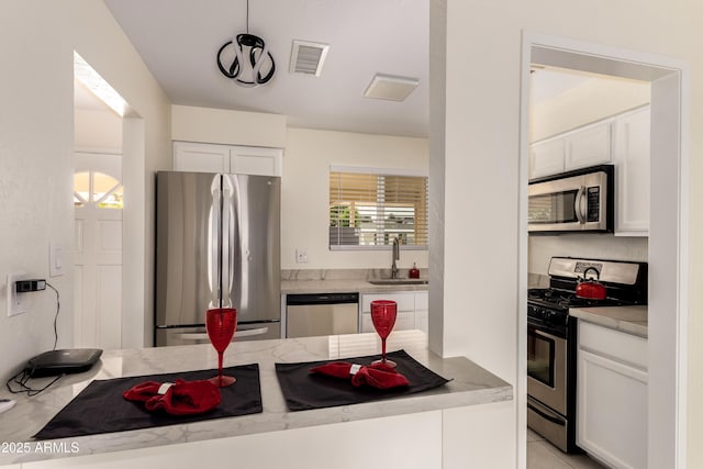 2130 W Colter St, Phoenix, AZ 85015 - kitchen with appliances with stainless steel finishes, a sink, white cabinets, and light countertops