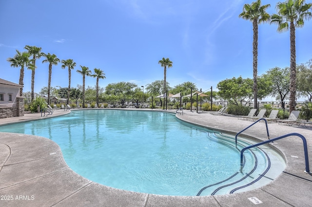 community pool featuring a patio area and fence