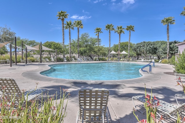 community pool featuring a patio area and fence