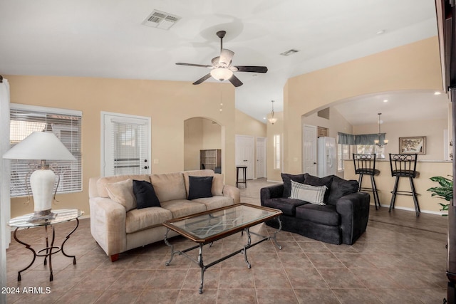 living room featuring ceiling fan and lofted ceiling