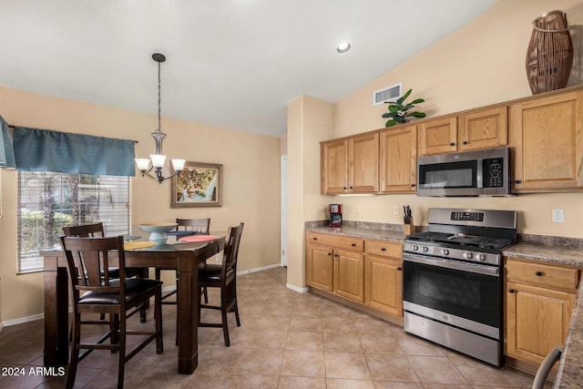 kitchen featuring pendant lighting, an inviting chandelier, vaulted ceiling, light tile patterned flooring, and stainless steel appliances