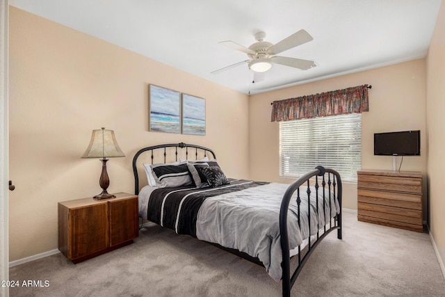 bedroom featuring ceiling fan and light carpet