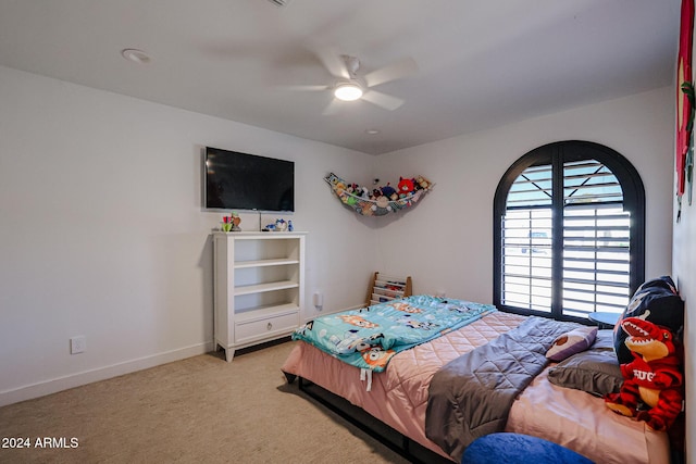 bedroom with light carpet and ceiling fan