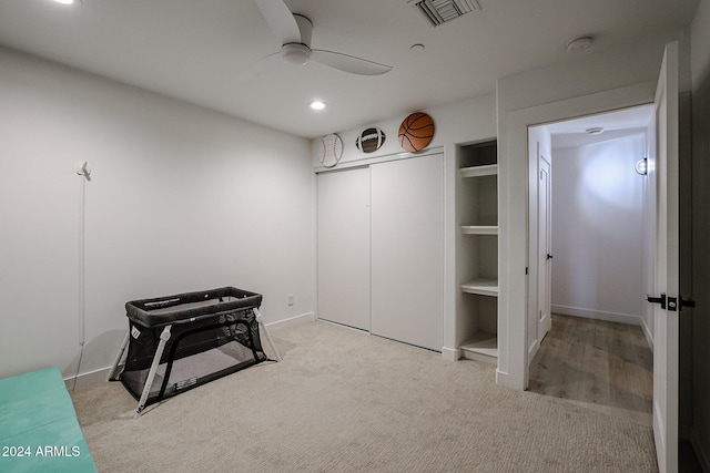 misc room with ceiling fan and light colored carpet