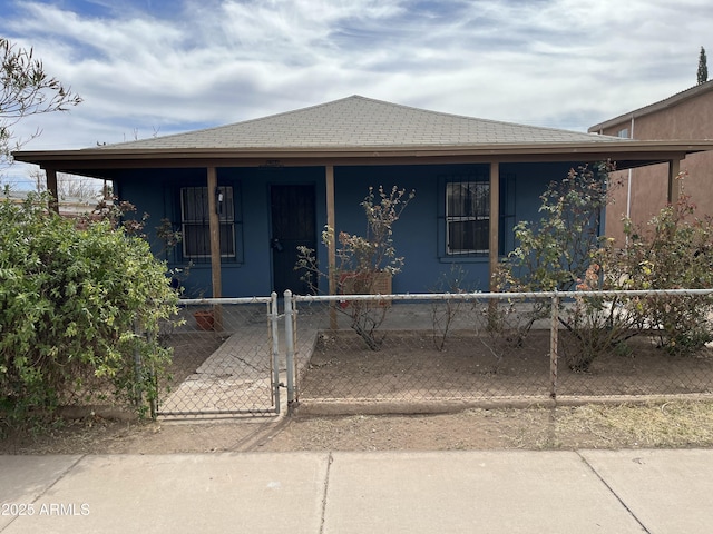 view of front of home featuring a porch, a fenced front yard, a gate, and stucco siding