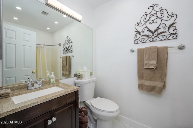 bathroom with vanity, curtained shower, and toilet