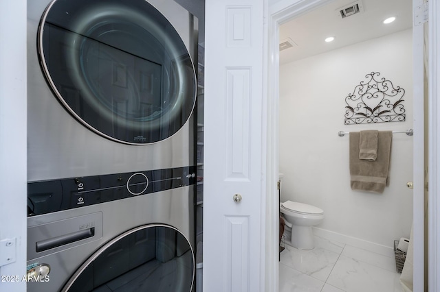 laundry room with stacked washing maching and dryer