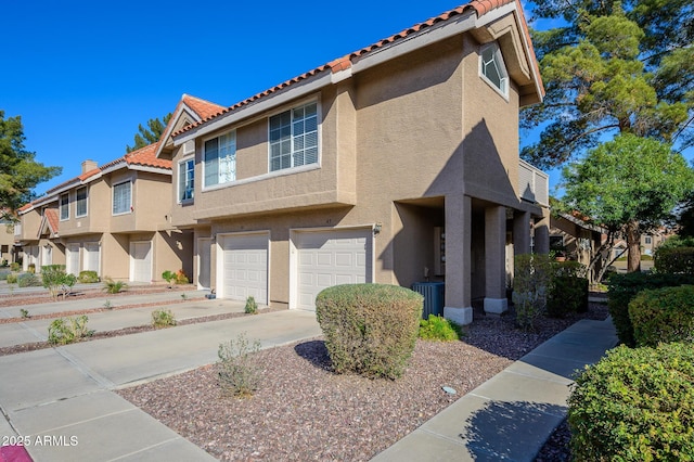 view of front of property with a garage and central AC unit