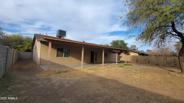 rear view of property with central AC and a patio area