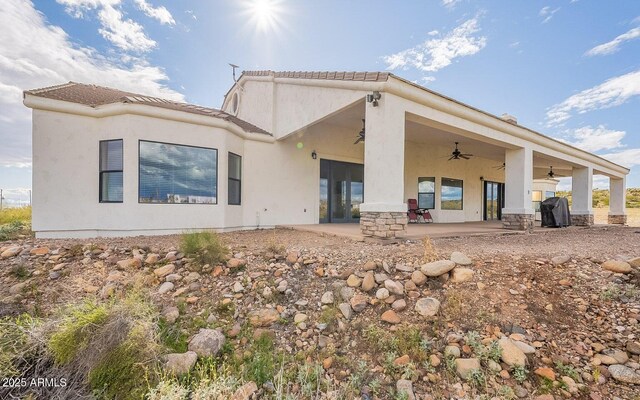 26215 N 115th Ave, Peoria, AZ 85383 - back of house with a ceiling fan, stucco siding, a patio, and a tile roof