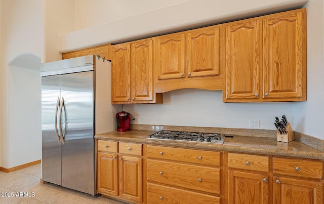 26215 N 115th Ave, Peoria, AZ 85383 - kitchen with stainless steel appliances, brown cabinets, and light tile patterned floors