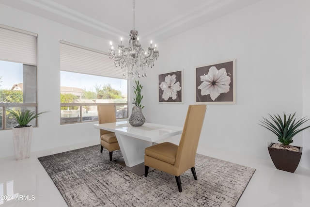 dining room featuring a wealth of natural light and an inviting chandelier