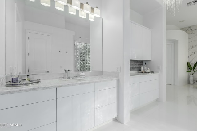 bathroom with vanity, tasteful backsplash, and tile patterned floors