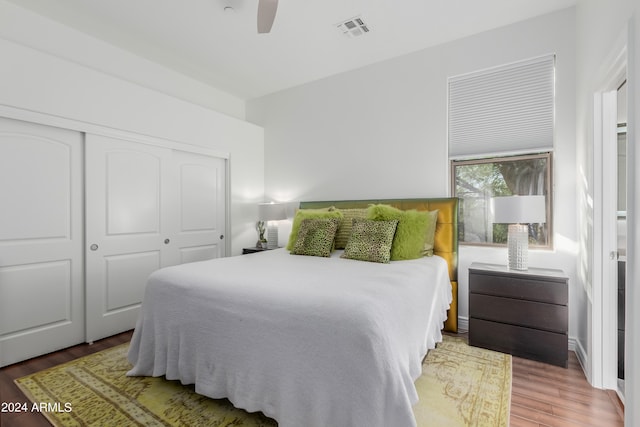 bedroom featuring a closet, hardwood / wood-style flooring, and ceiling fan