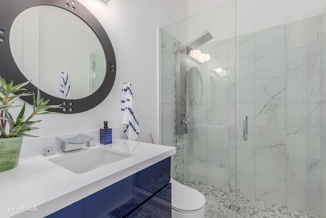 bathroom featuring vanity, toilet, and walk in shower