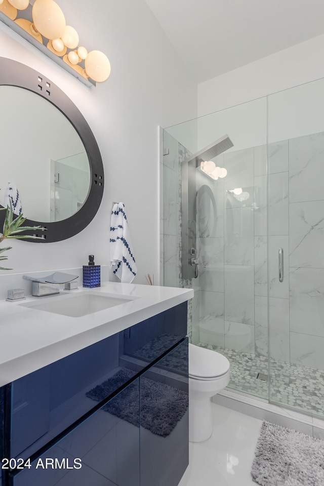 bathroom featuring vanity, toilet, and walk in shower