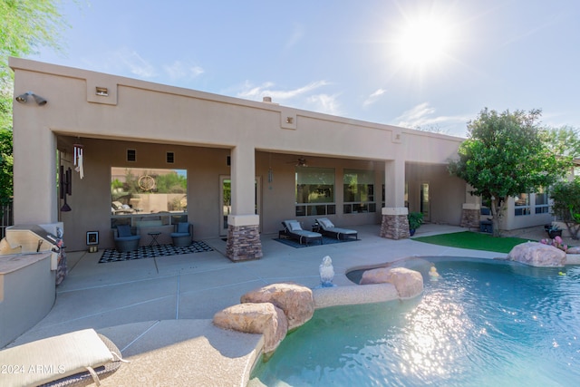 view of swimming pool with outdoor lounge area, a patio, and ceiling fan